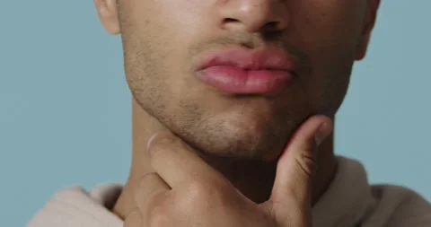 Closeup of man applying cream on beard zone. Handsome guy putting moisturizer Stock Footage 222419103