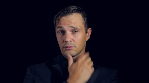 Closeup of a man in black clothes on black background. 4k. Slow motion. man Stock Footage 80005446