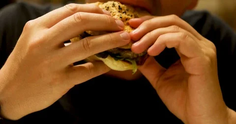 Closeup of man with burger Stock Footage 103272906