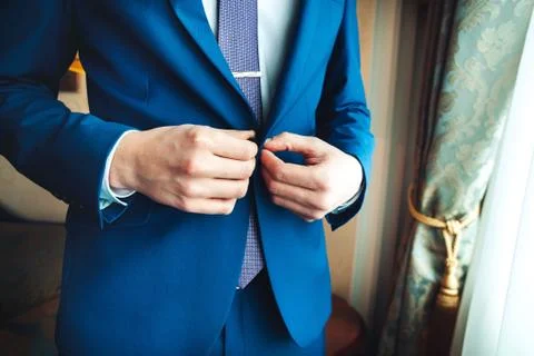 Closeup of man buttoning his jacket, business clothing concept Stock Photos