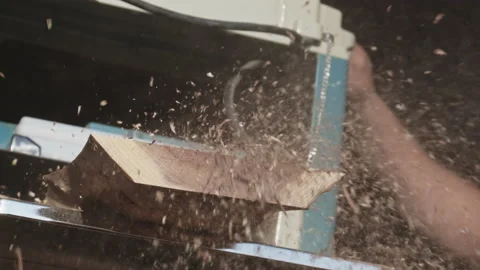 Closeup of a man carpenter working with a thickness planer. Dust flying out Stock Footage 205944335