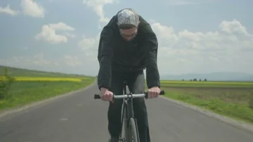 Closeup, a man chasing with a bike, trying to achieve the goals 4k Stock Footage 85557830