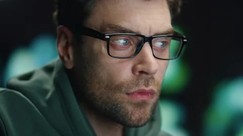 Closeup man coder working night datacenter. Serious developer looking computer Stock Footage 260253215