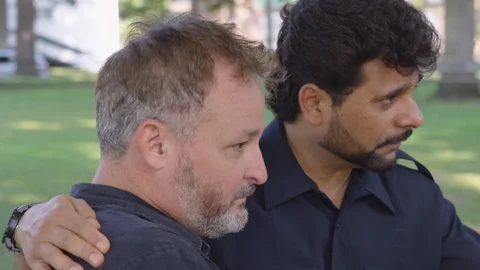 Closeup - A man comforts another man outside at a park - shot on RED Stock Footage 124911471