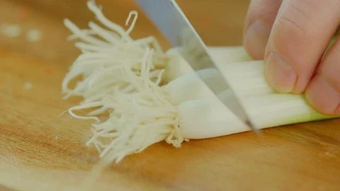 Closeup Of Man Cutting Spring Onion On Chopping Board Stock Footage 86069561