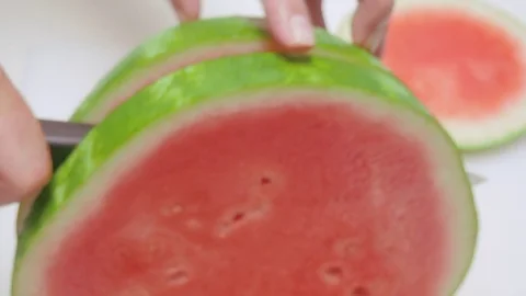 Closeup of a Man Cutting a Watermelon into Rings Stock Footage 79051291