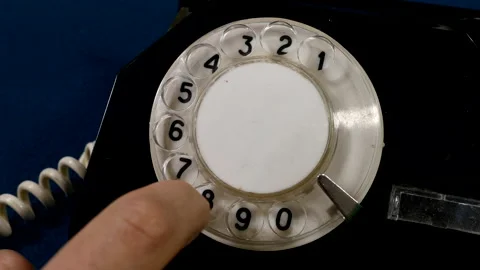 Closeup of man dials old rotary phone Stock Footage 223491072
