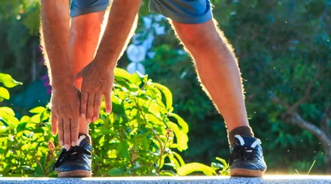 Closeup Man Does Morning Exercises Bends Hands to Foot in Park Stock Footage 59587792