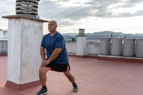 Closeup of a man doing exercises and sports on the terrace of a building Fotos de archivo
