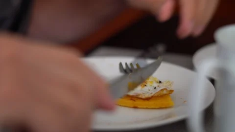 Closeup of man eating corn bread and egg breakfast Stock Footage 96068383