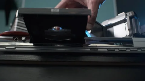 Closeup of Man Ejecting Disc from DVD Player Stock Footage 169704666