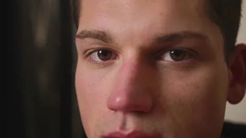 Closeup of man Face looking at camera, man has beautiful brown Eyes. Natural Stock Footage 148383701
