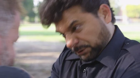 Closeup - A man gets in another man's face and shakes him around violently - Stock Footage 124911538