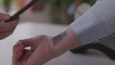 Closeup of a Man Getting a QR Code on the Inside of His Wrist Scanned Video stock 208797880
