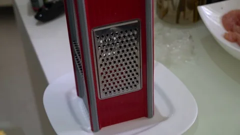 Closeup of man grating cheese 스톡 동영상 75688267