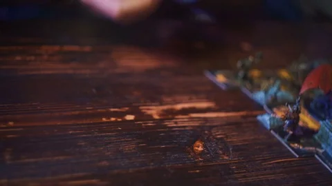 Closeup of man hand in armor rolling dice with shaker cup for fantasy board game Stock Footage 79441183