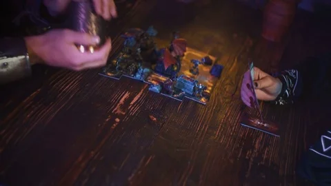 Closeup of man hand in armor rolling dice with shaker cup for fantasy board game Stock-Footage 79441609