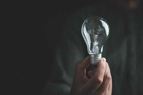 A closeup man hand gesture to pose with a sign of a bright idea, the lightb.. Stock Photos