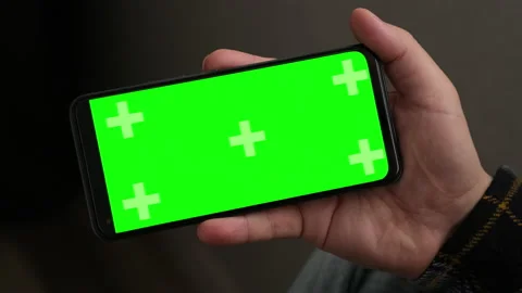 Closeup man Hand is Holding Chroma Key Green Screen in horizontal Position Stock Footage 236312843