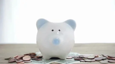 Closeup man hand put coin money to piggy bank, savings and deposit money co.. Stock Footage 265935153