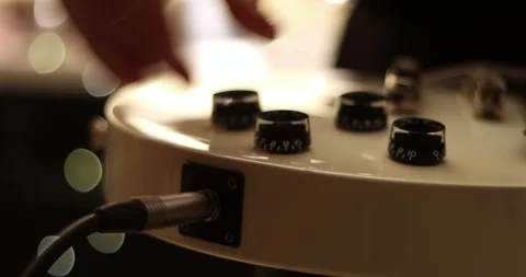 Closeup man hand sticking plug to guitar in concert hall. Unrecognizable pers Stock Footage 305769864