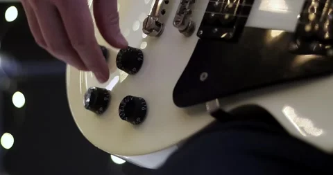 Closeup man hand sticking plug to guitar in concert hall. Unrecognizable pers Stock Footage 305770105