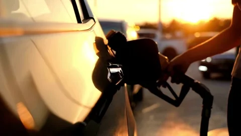 Closeup of man hand using petrol pump to filling car up with fuel standing ne Stock Footage 256722690