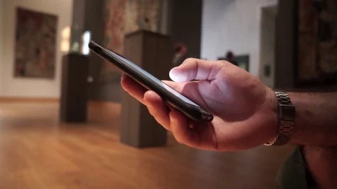Closeup of man hand using smartphone at the museum Stock Footage 77280815