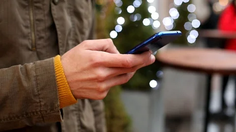Closeup of man hand using smartphone outside. Winter traveling. Online 스톡 동영상 124712305