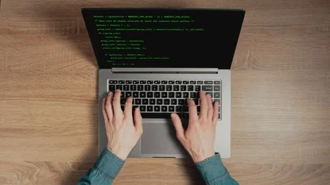 Closeup a man hands are typing commands of a laptop keyboard. A man is writing a Stock Footage 150431141