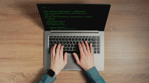 Closeup a man hands are typing commands of a laptop keyboard. A man is writing a Stock Footage 154707665