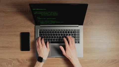 Closeup a man hands are typing commands of a laptop keyboard. A man is writing a Stock Footage 156835155