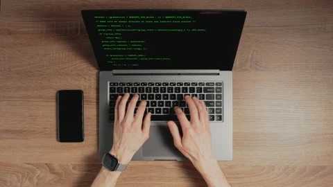 Closeup a man hands are typing commands of a laptop keyboard. A man is writing a Stock Footage 164553701