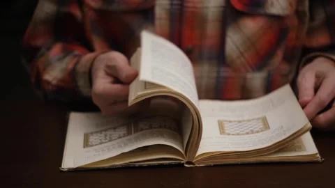 Closeup man hands flips through blur pages book to study chess game. front view. Video stock 304306861