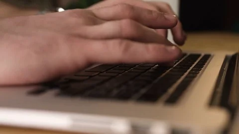 Closeup man hands on the keyboard uses laptop in office Stock Footage