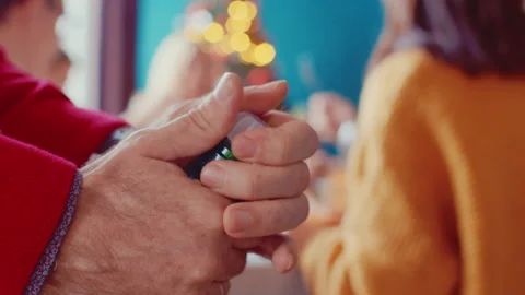 Closeup of man hands opening bottle of champagne on background of Christmas Stock Footage 144554051