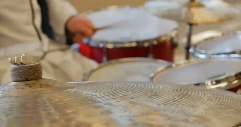 Closeup of man hands playing a cymbal part of a red drumset.  Stock Footage 103257517