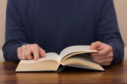 Closeup of man hands reading book Stock Photos