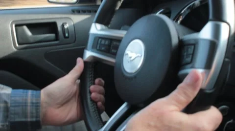 Closeup of man hands on steering wheel of mustang Stock Footage 44666757