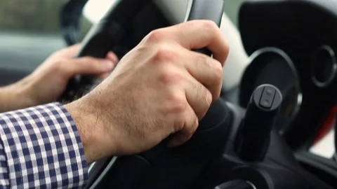 Closeup of man hands on steering wheel driving car. Stock Footage 104193198
