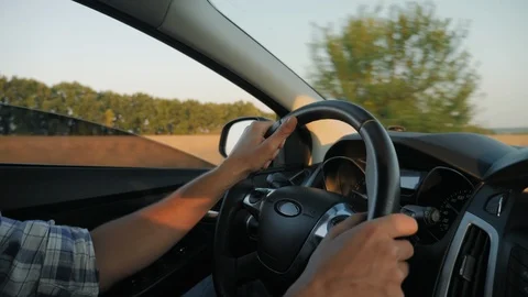 Closeup of man hands on steering wheel driving car Stock Footage 115762477