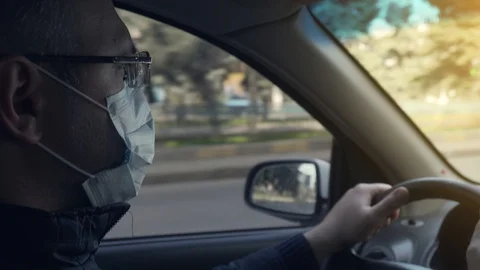 Closeup of man hands on steering wheel driving car during pandemic of corona Video stock 127652716