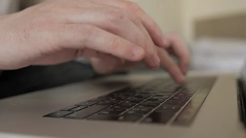 Closeup of man hands typing on laptop keyboard at the desk in home office Stock Footage 247010976