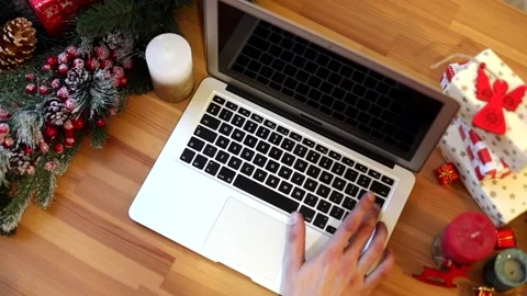 Closeup of man hands using laptop keyboard. Christmas decoration on background.  스톡 동영상 146304138