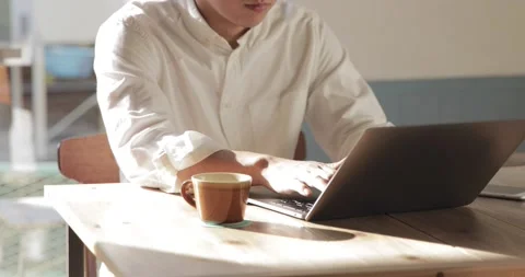Closeup of man hands using laptop at a cafe Stock Footage 152197181
