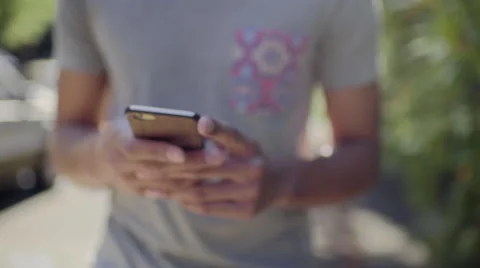 Closeup Of Man Hands Using A Smart Phone As He Walks Through Neighborhood Video stock 51741738