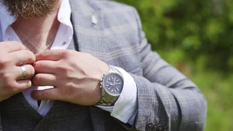 Closeup man hands with wrist watch in park. Rich man buttoning up shirt. Stock Footage 204925683