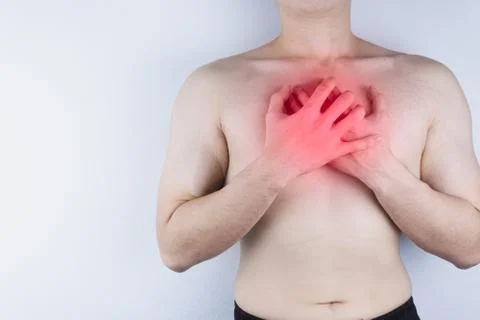 Closeup man having heart attack or chest pain with red spot. Health care and  Stock Photos