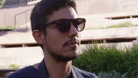 Closeup of man holding a camera up to take a picture and putting it back down - Stock Footage 123441452