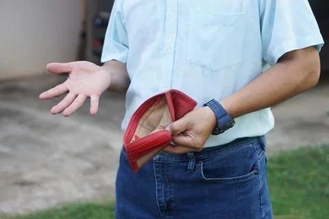 Closeup man holds empty red wallet with no momey Stock Photos